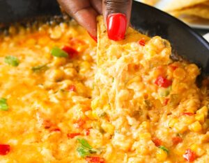 Diving into hot corn dip fresh from the oven, pulling up tender corn and gooey cheese for the win