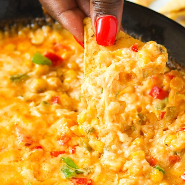 Diving into hot corn dip fresh from the oven, pulling up tender corn and gooey cheese for the win