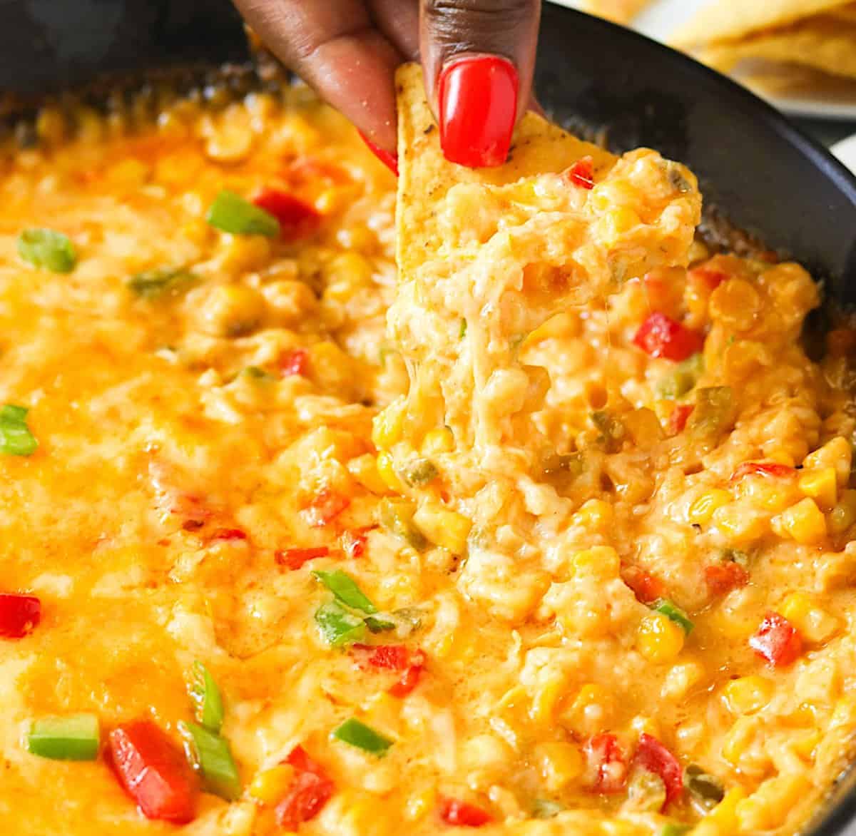 Diving into hot corn dip fresh from the oven, pulling up tender corn and gooey cheese for the win