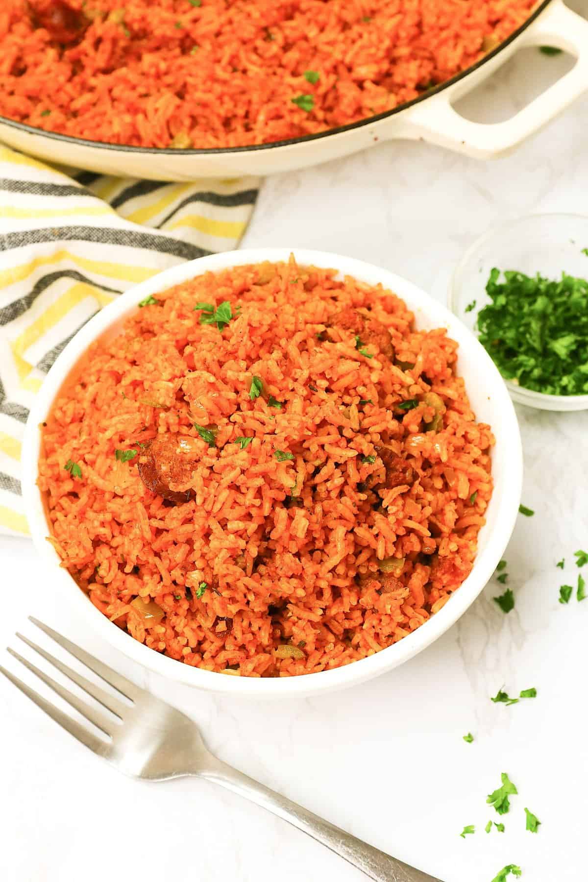 Steaming hot Charleston Red Rice served up in a white bowl and ready to enjoy