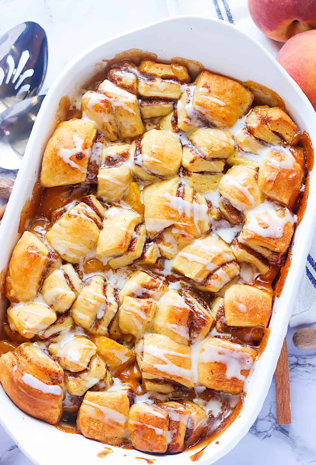 Glazed Cinnamon Roll Peach Cobbler for the ultimate comfort food dessert