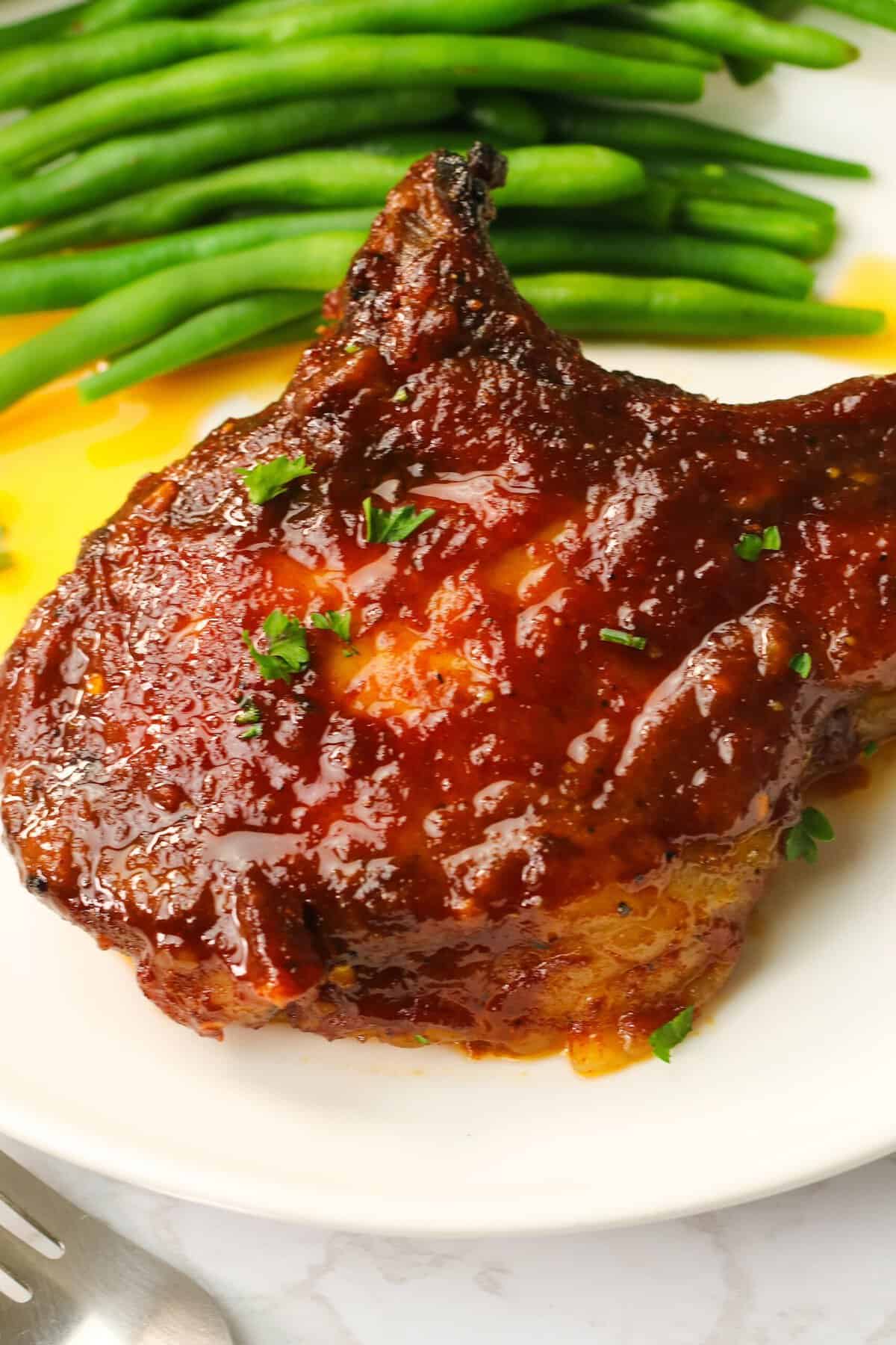 Delectable Oven BBQ Pork Chops with roasted green beans for a wholesome dinner