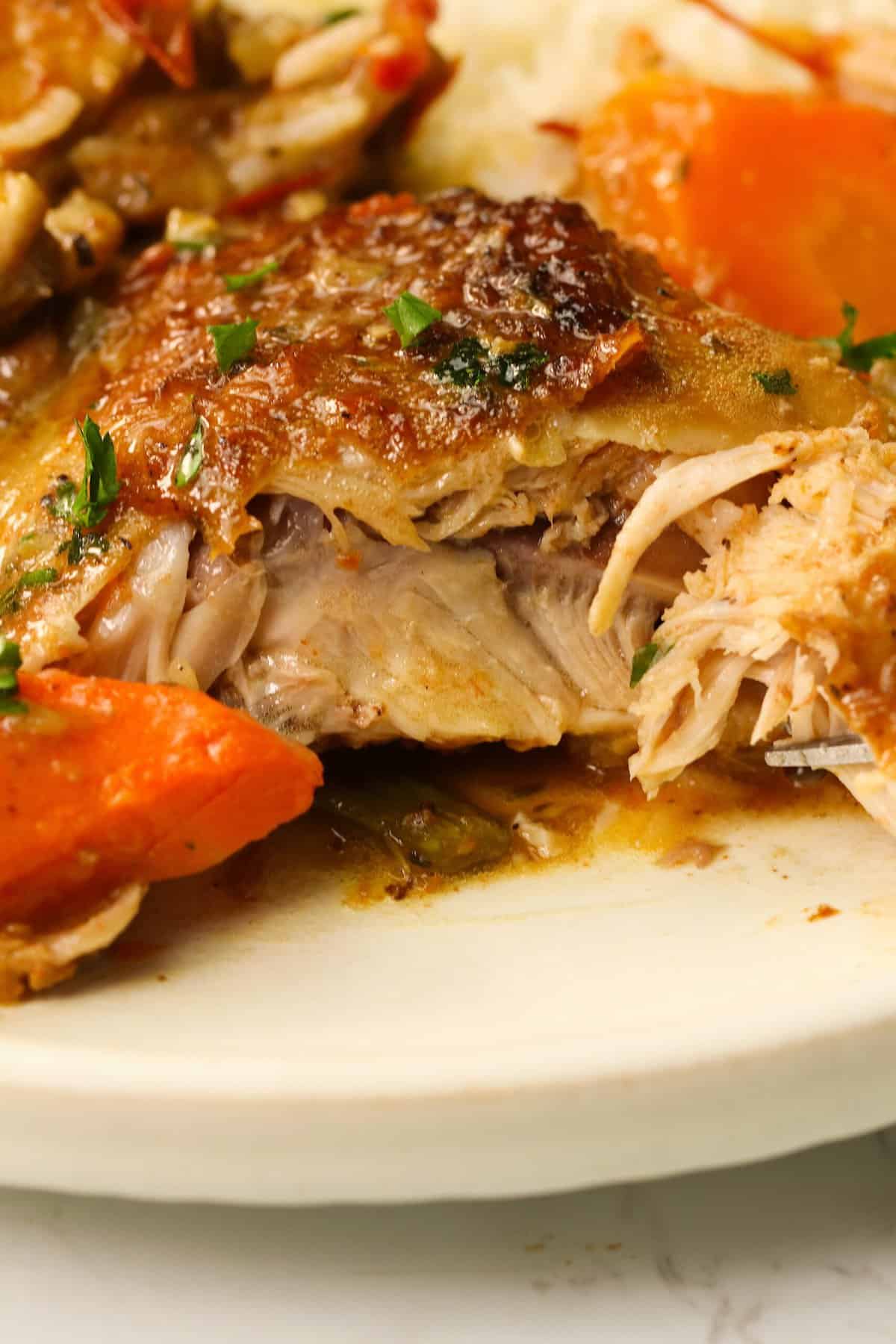 Cutting a tender Braised Chicken Thighs with a fork