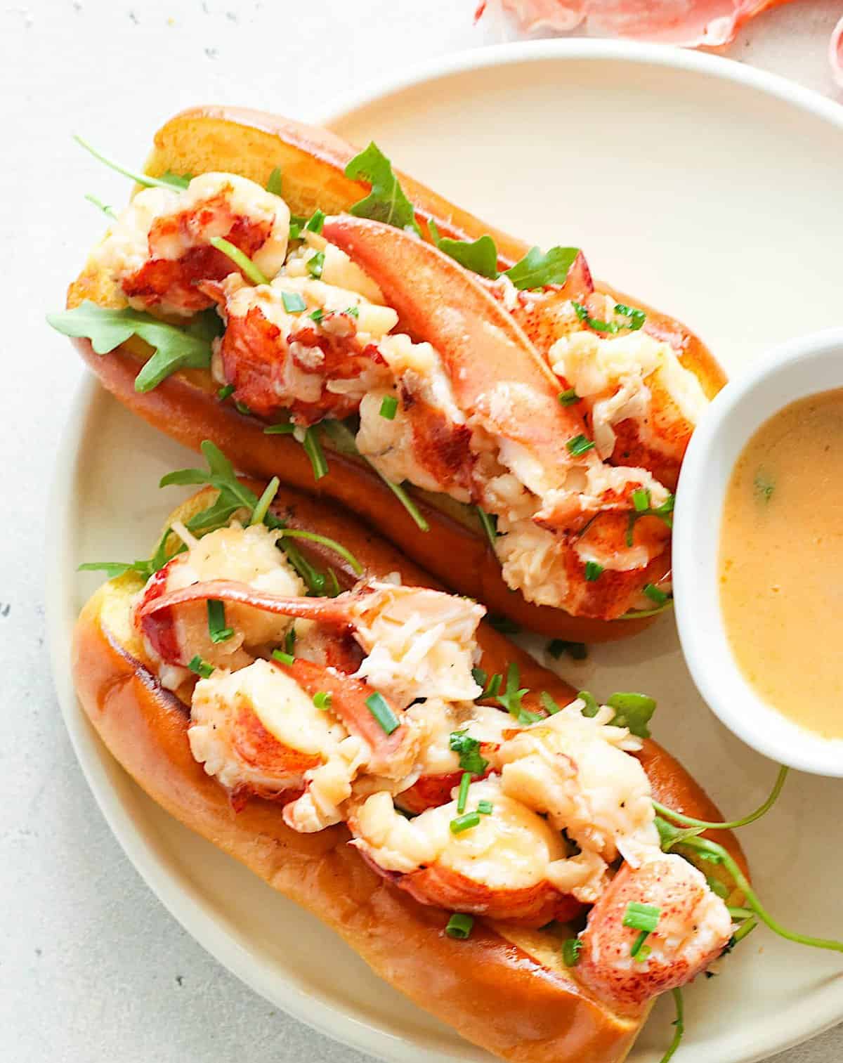 Two Connecticut Lobster Rolls and herbed butter for dipping for a delectable lunch