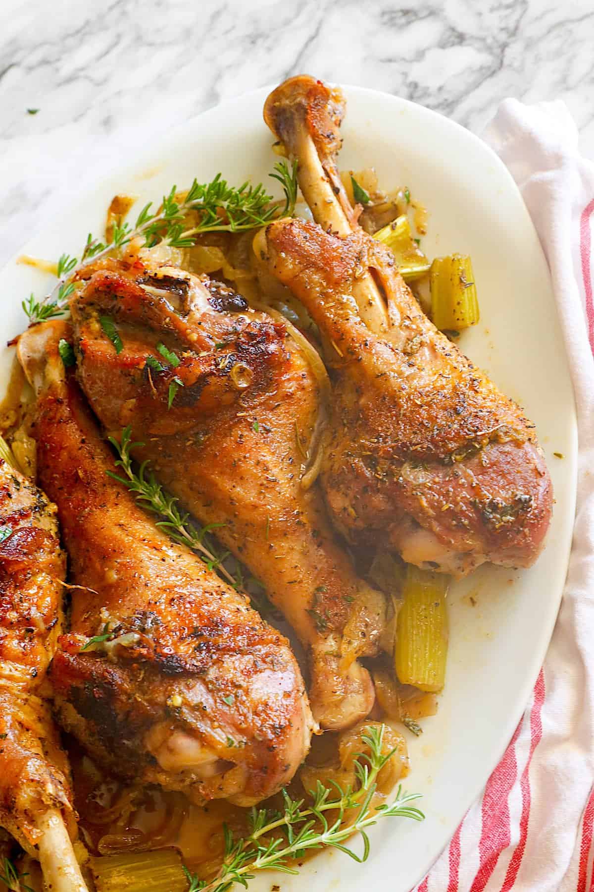 Roast Turkey Legs fresh from the oven on a white platter ready to enjoy