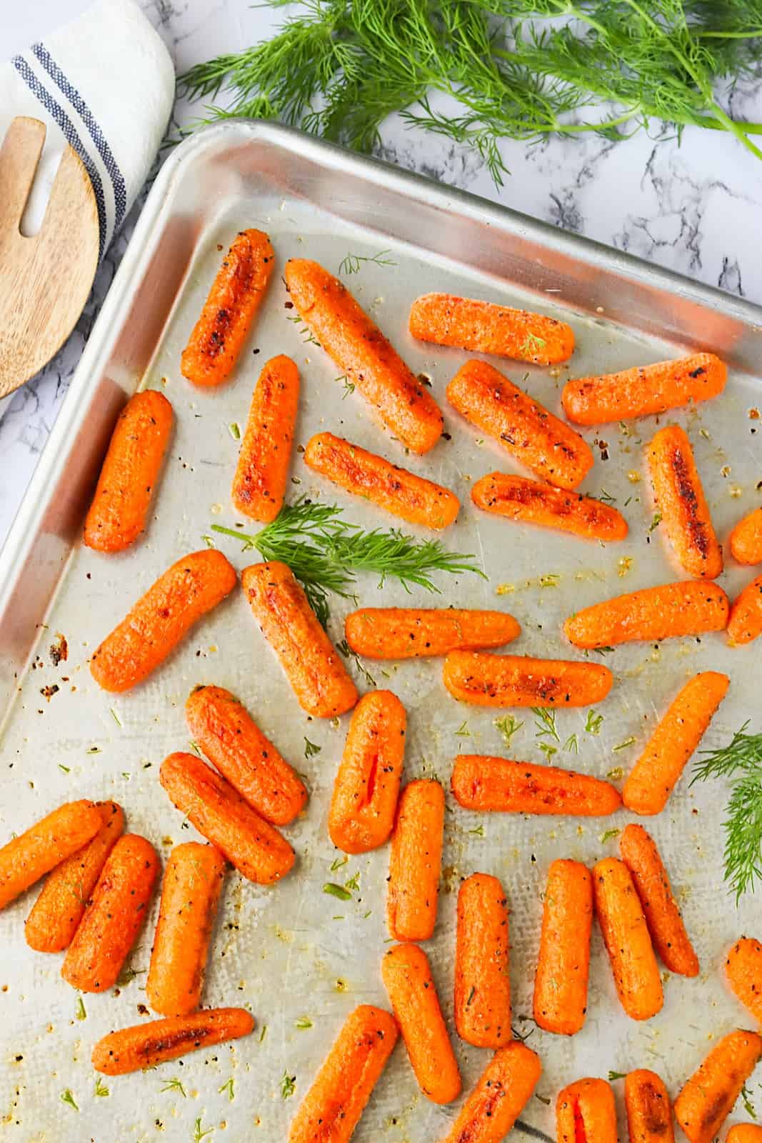 Freshly Roasted Baby Carrots with a sprig of fresh dill ready to serve