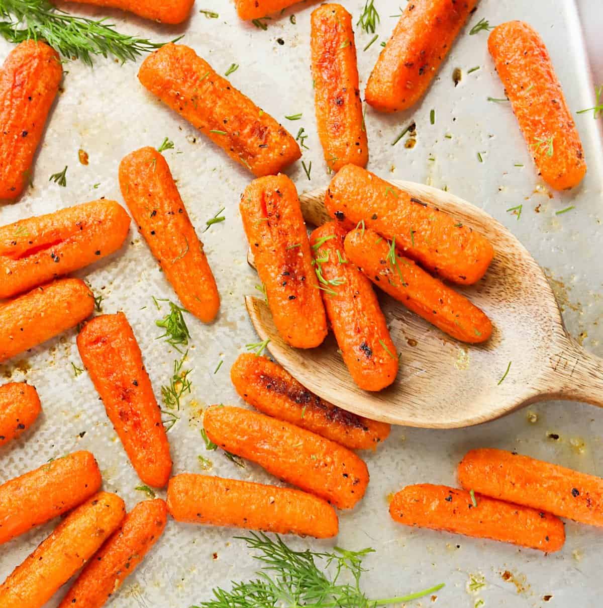 Serving up savory Roasted Baby Carrots with a wooden spoon for a soul-satisfying side