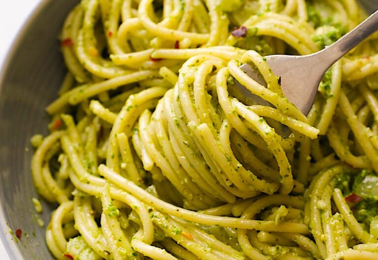 Spinning pasta on a fork, getting ready to take a tasty bite of pesto pasta