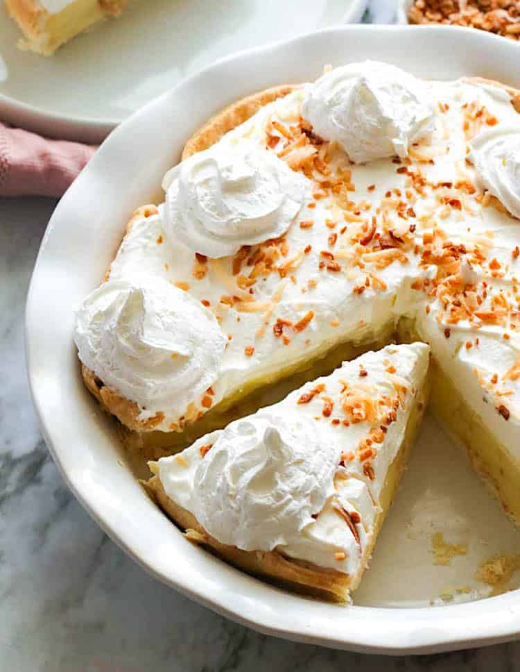 A hearty coconut cream pie topped with homemade whipped cream and toasted coconut.