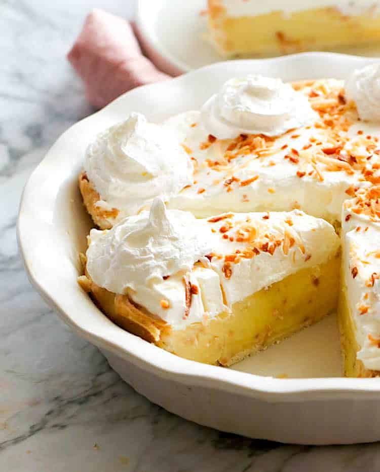 Slices of ridiculously delicious coconut cream pie topped with whipped cream