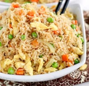 Enjoying delicious coconut fried rice with chopsticks