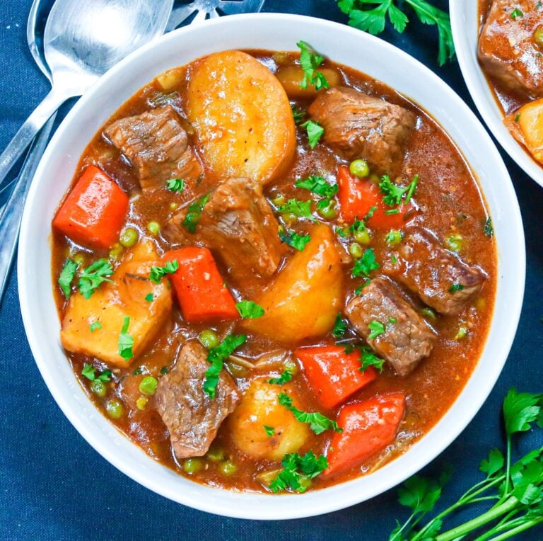 Two bowls of steaming beef stew made in a Dutch oven for pure satisfaction