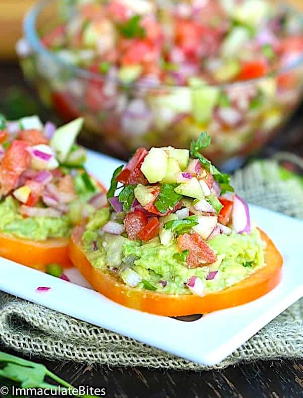 Insanely good kachumbari stacked on tomatoes and mashed avocados