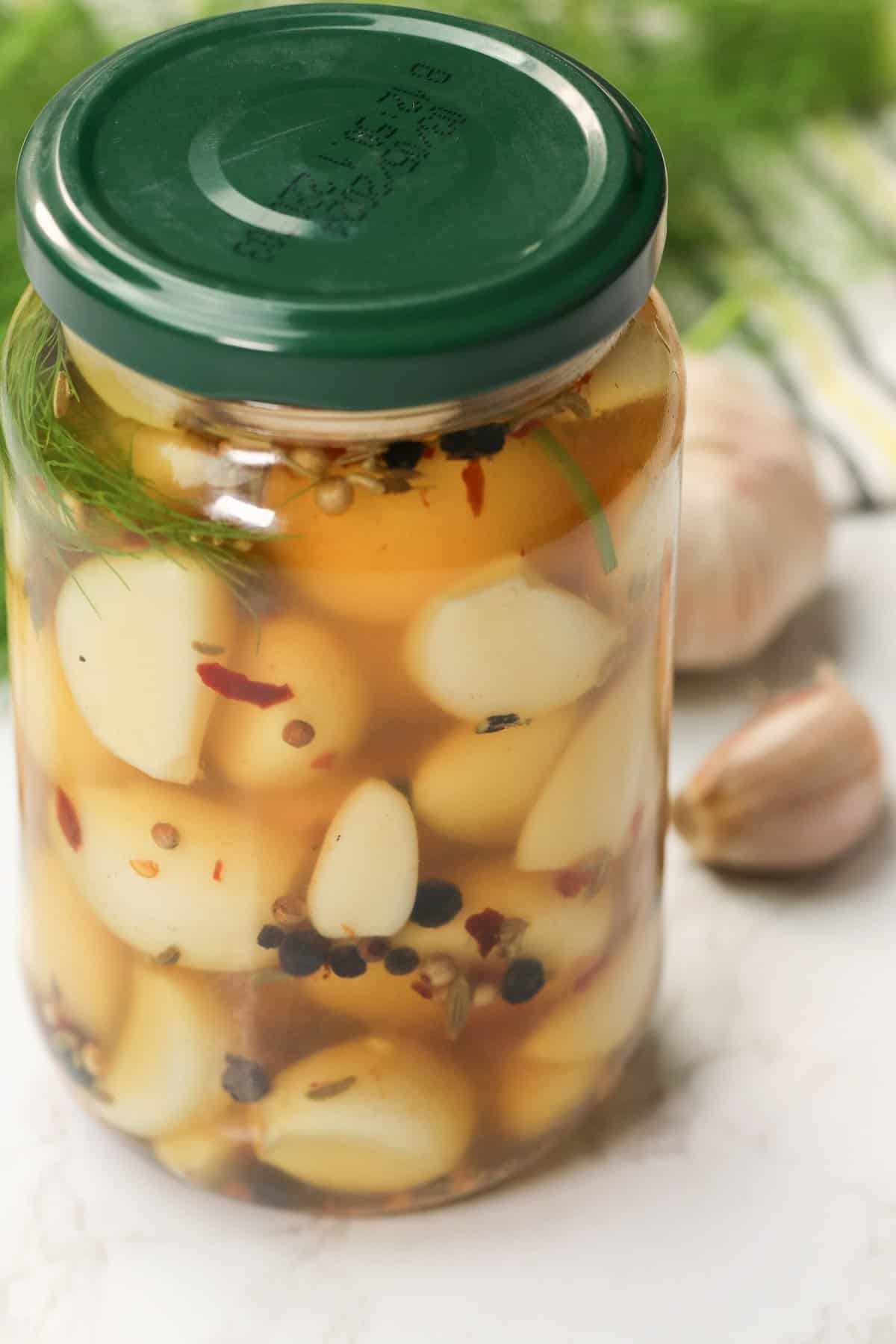 A jar of delicious pickled garlic for a healthy condiment