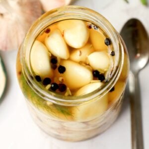 A full jar of pickled garlic ready to be enjoyed