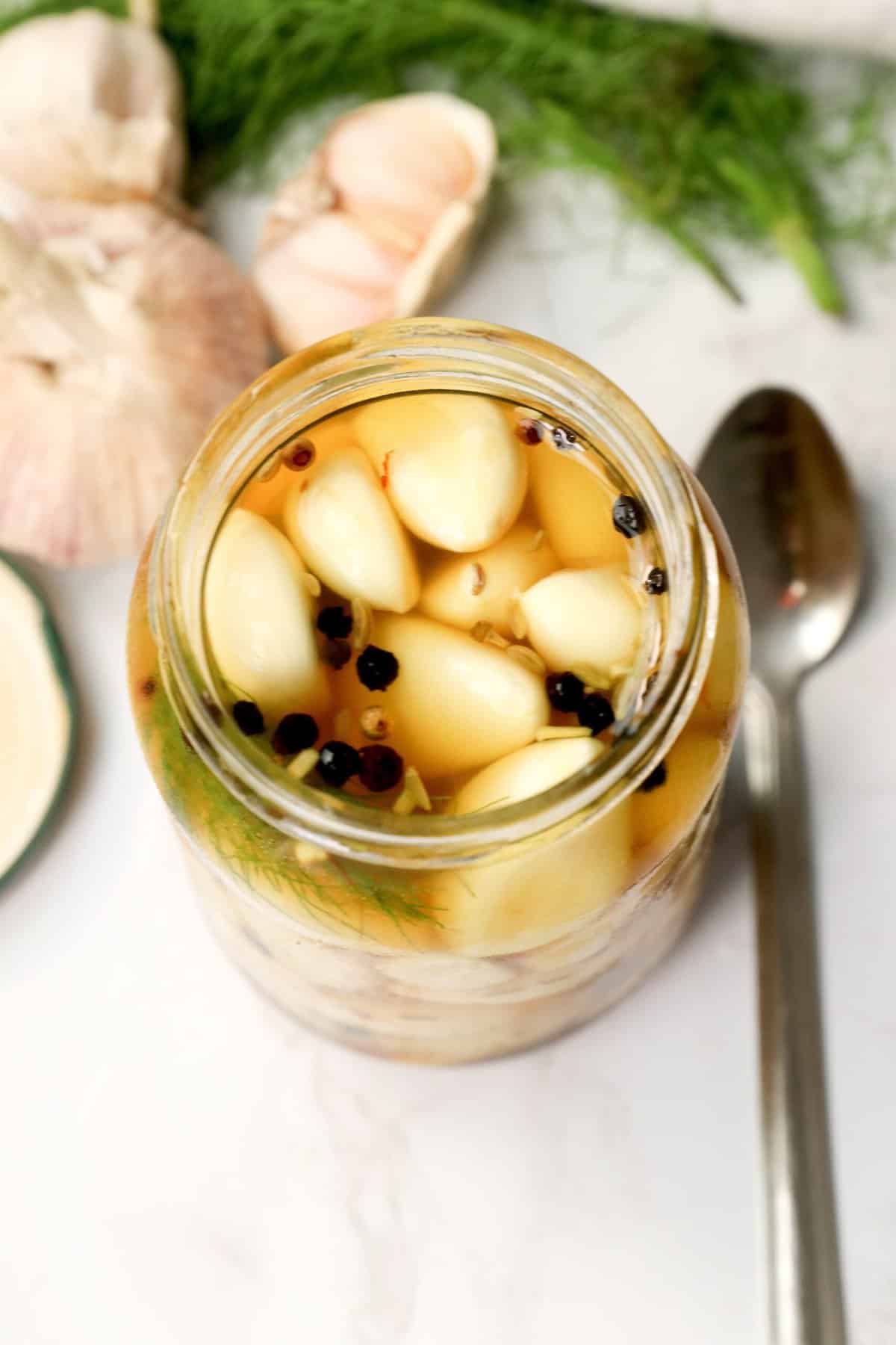 A full jar of pickled garlic ready to be enjoyed