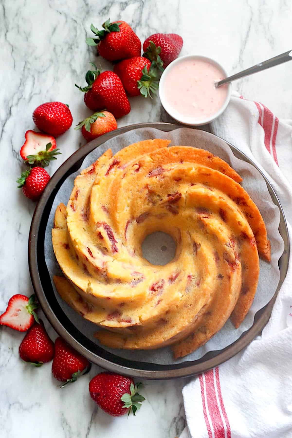 Glazing a gorgeous Strawberry Bundt Cake for pure comfort food