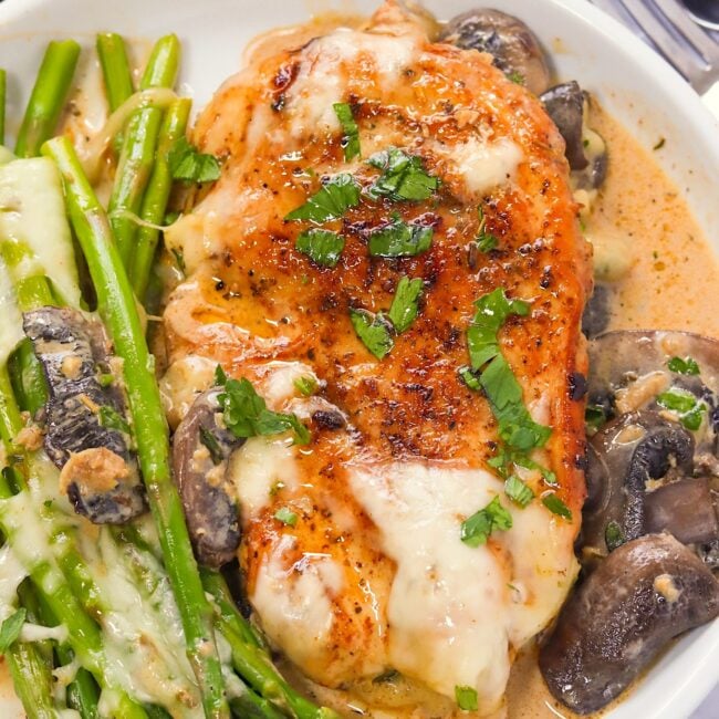 Serving up a delicious plate of chicken Madeira with asparagus over seasoned rice