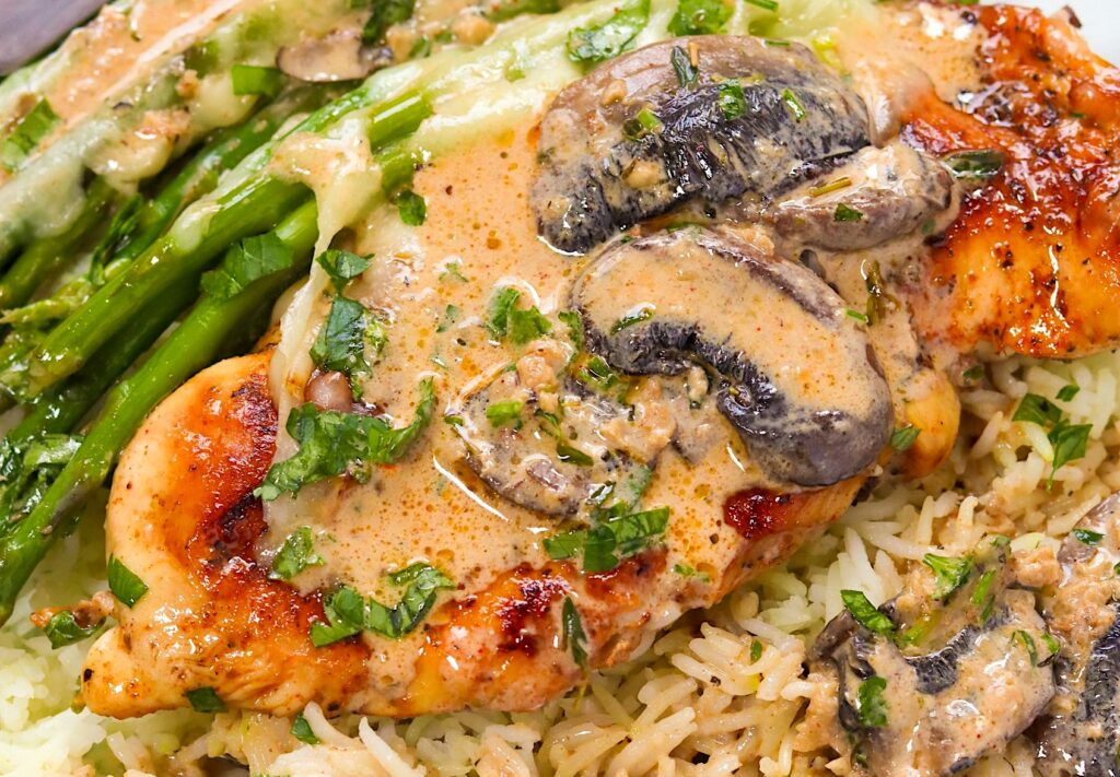 Serving chicken Maderia with seasoned rice and asparagus