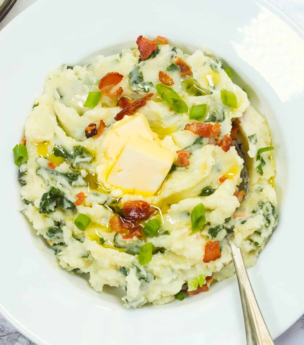Enjoy a satisfying bowl of colcannon potatoes loaded with butter and bacon