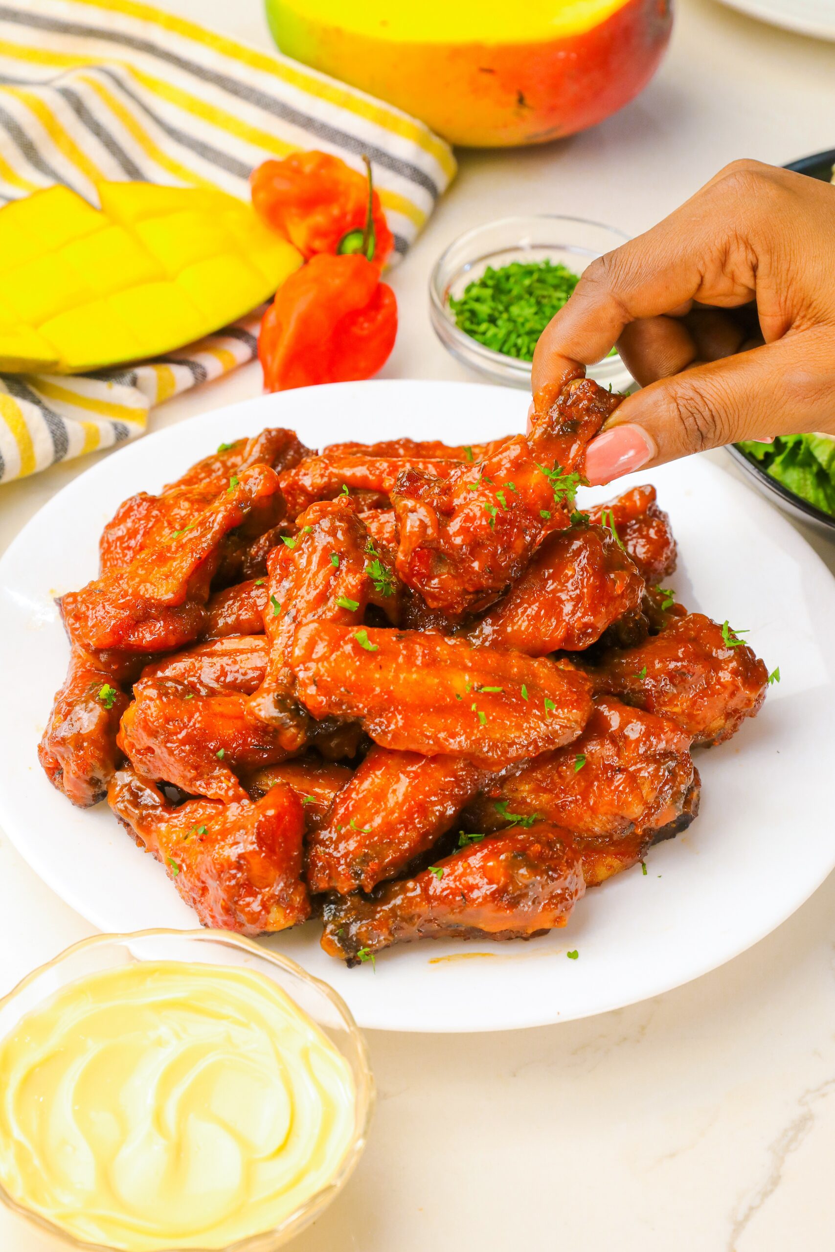 Grabbing a spicy mango habanero chicken wing to enjoy