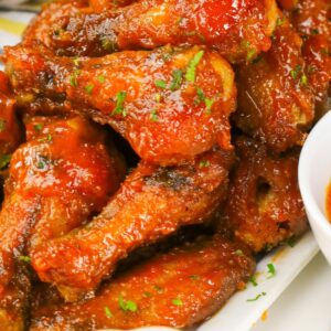 Mango Habanero Wings loaded up on a platter with more spicy dipping sauce and remoulade to cool it down if needed