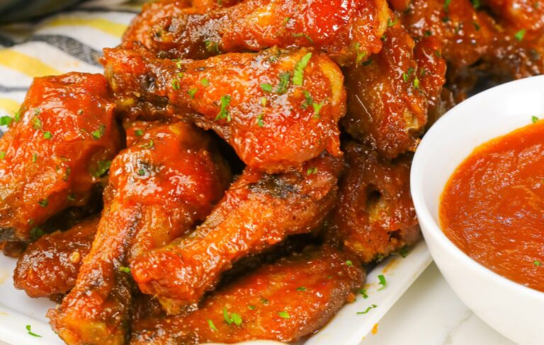Mango Habanero Wings loaded up on a platter with more spicy dipping sauce and remoulade to cool it down if needed