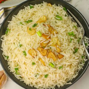 Serving up a savory bowl of garlic rice with a spicy main dish