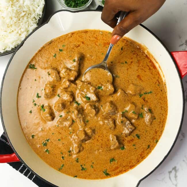 Serving homemade African peanut soup straight from the skillet.