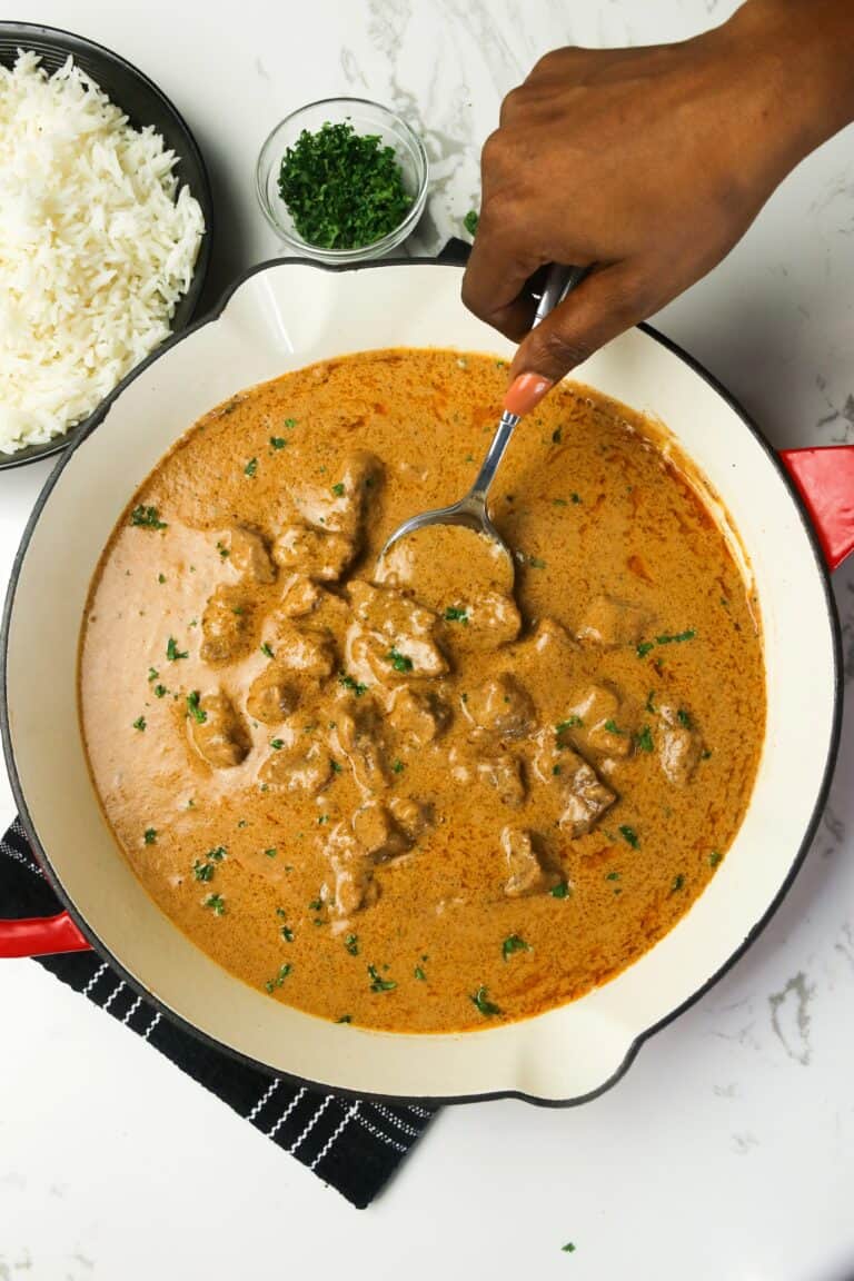 Serving homemade African peanut soup straight from the skillet.