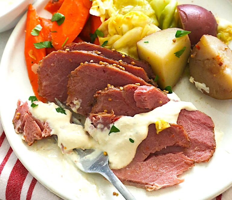 Drizzling slow cooker corned beef and cabbage drizzled with a delectable sauce