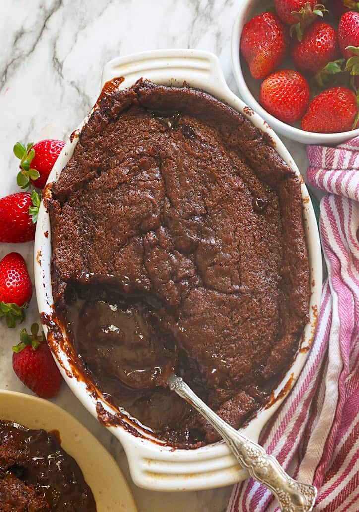 Indulgent chocolate cobbler served with fresh strawberries