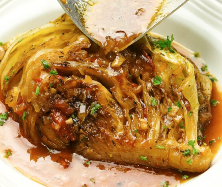Drizzling a cabbage wedge with flavorful braising liquid
