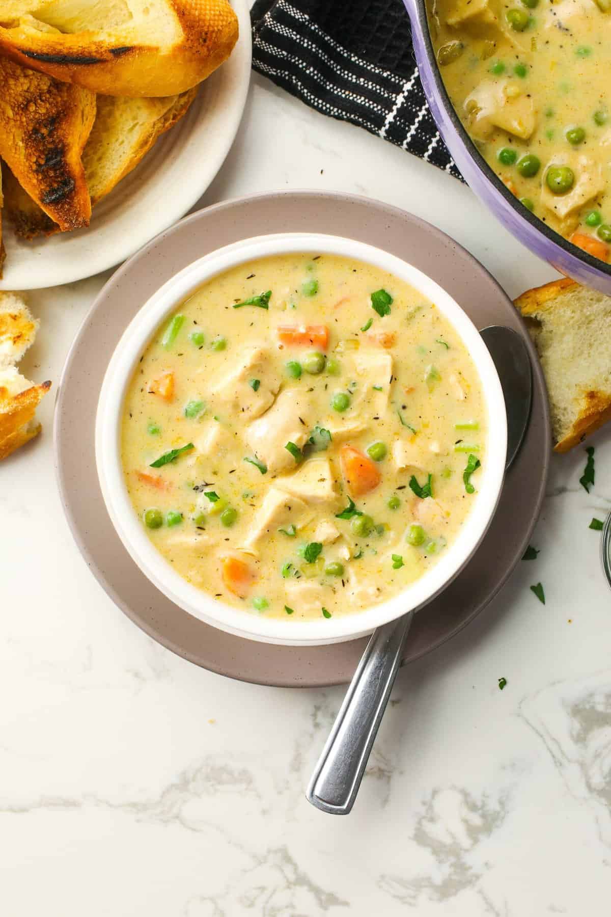 Serving up chicken pot pie soup with freshly baked bread
