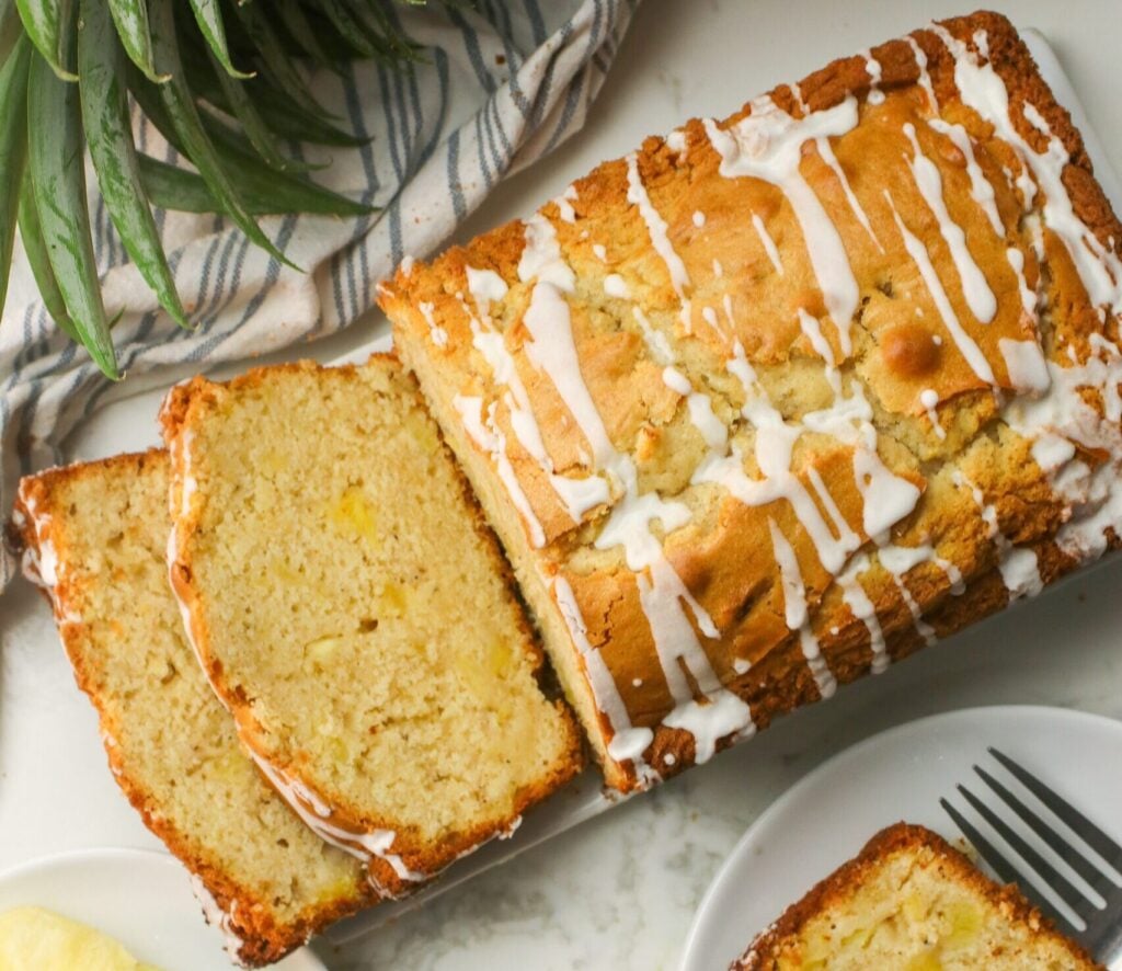 Slicing freshly glazed pineapple bread for a delectable afternoon snack