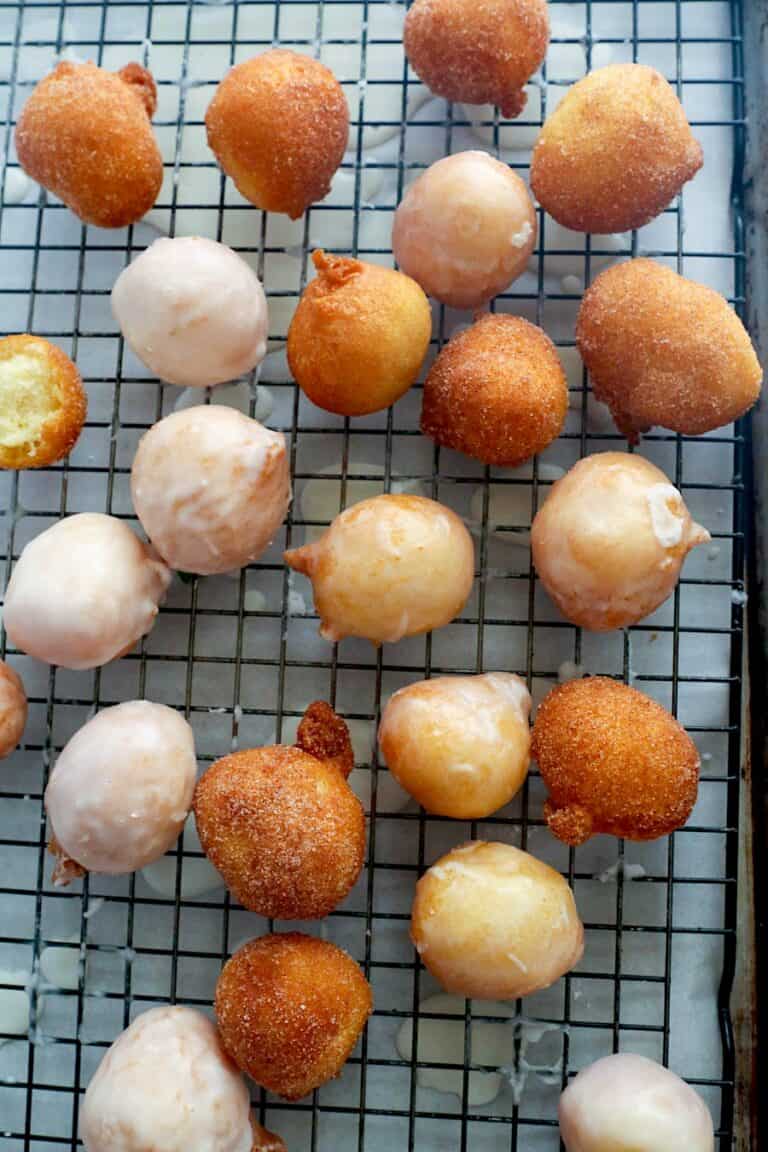 Freshly glazed donut holes with some covered in cinnamon sugar