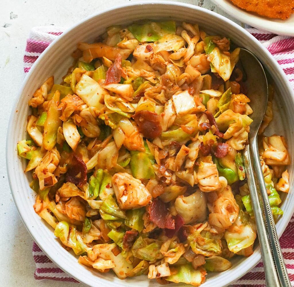 Serving up a bowl of freshly Southern fried cabbage with hot water cornbread