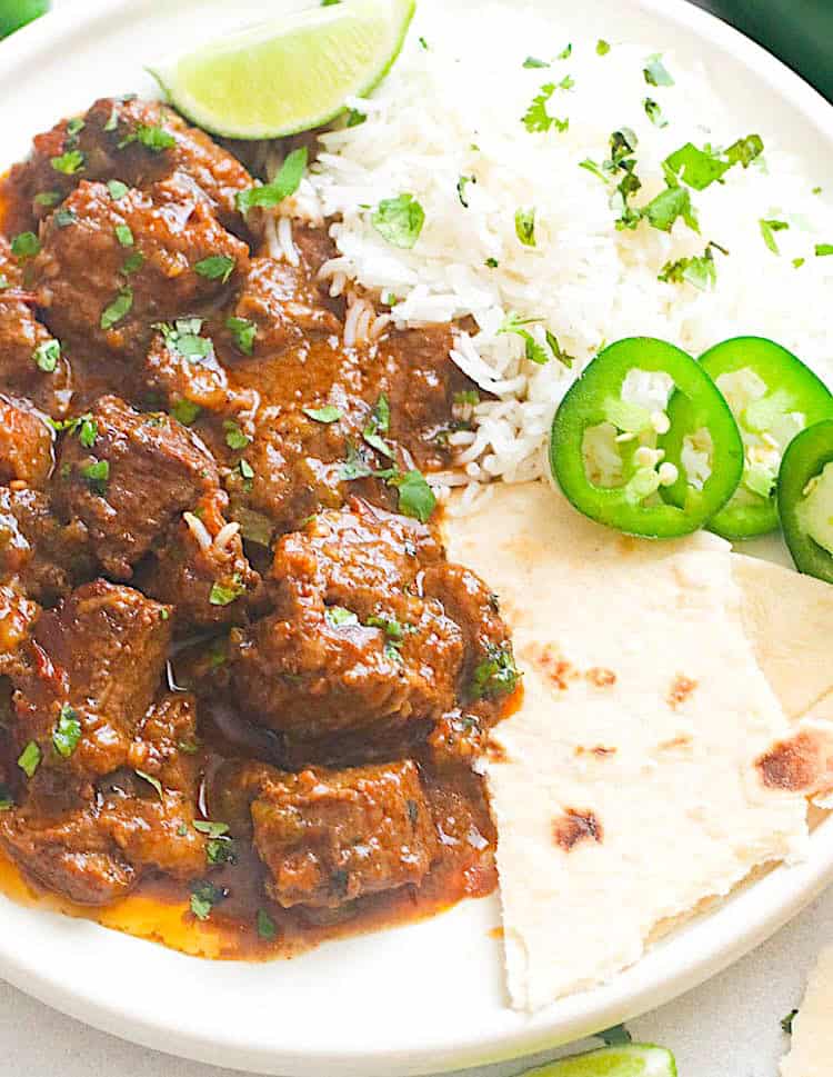 Serve up homemade carne guisada with rice, tortillas, and freshly sliced jalapenos