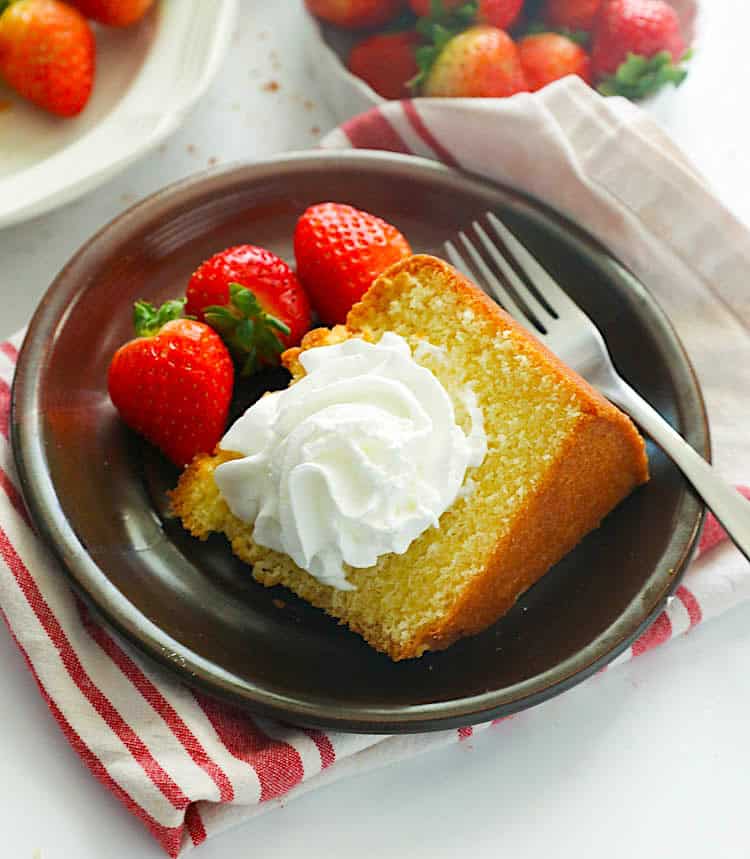 Enjoy Southern pound cake topped with fresh strawberries and homemade whipped cream