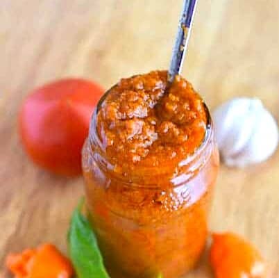 Storing homemade African pepper sauce in a jar.