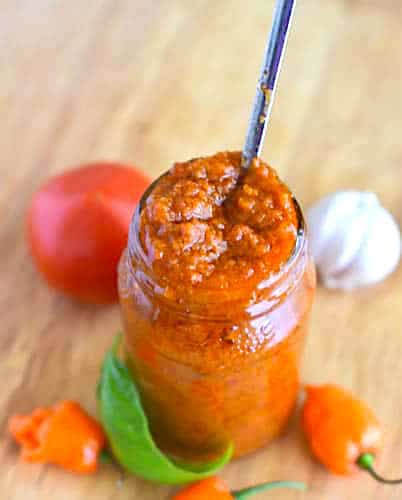 Storing homemade African pepper sauce in a jar.