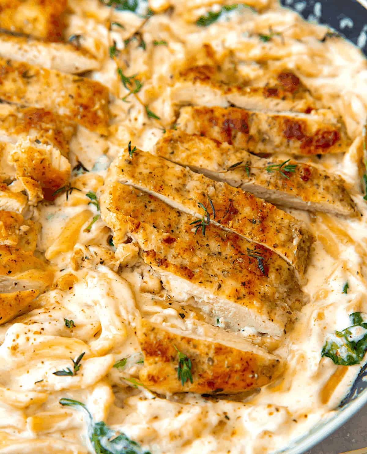 Serving up seasoned chicken breasts with penne pasta and Alfredo sauce