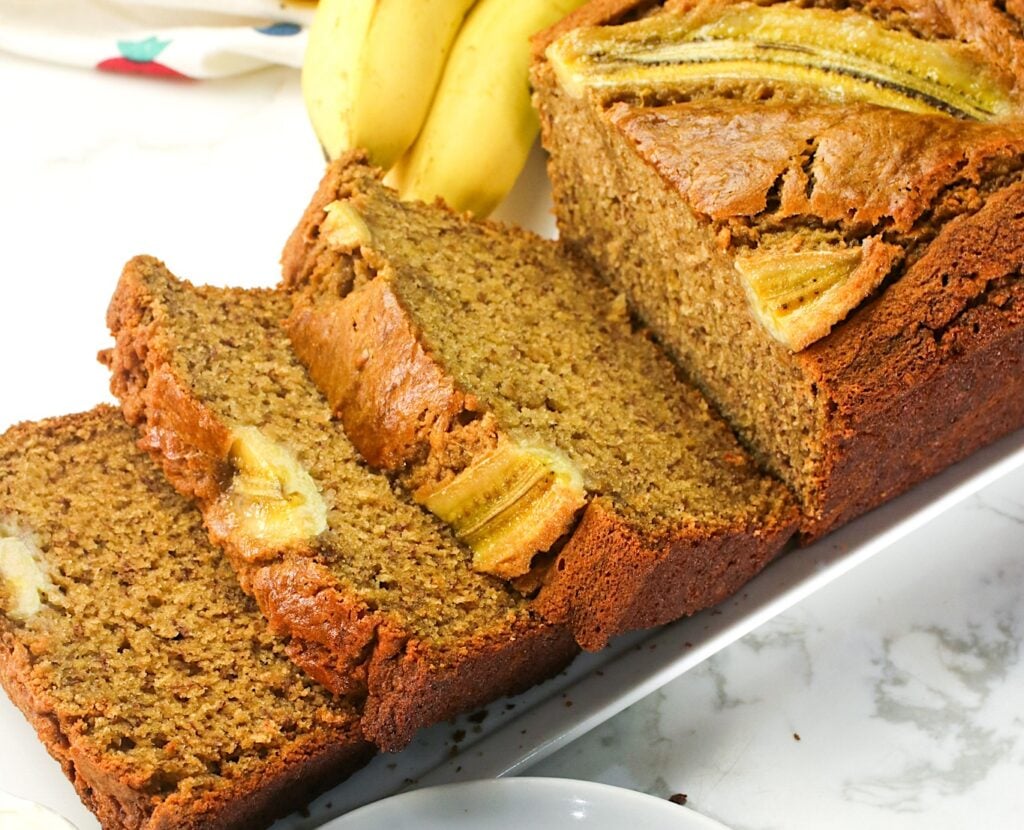 Slicing into fresh brown butter banana bread for an elevated snack