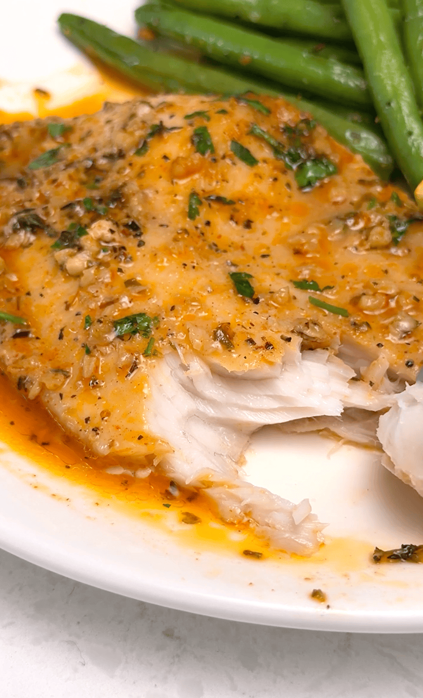 Forking into a flaky, saucy tilapia fillet.
