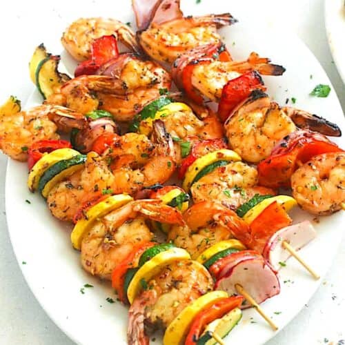A platter loaded with insanely good grilled shrimp kabobs