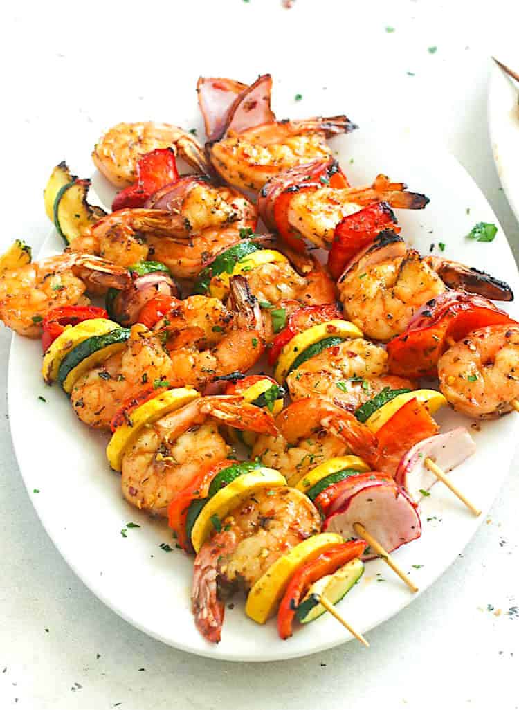 A platter loaded with insanely good grilled shrimp kabobs
