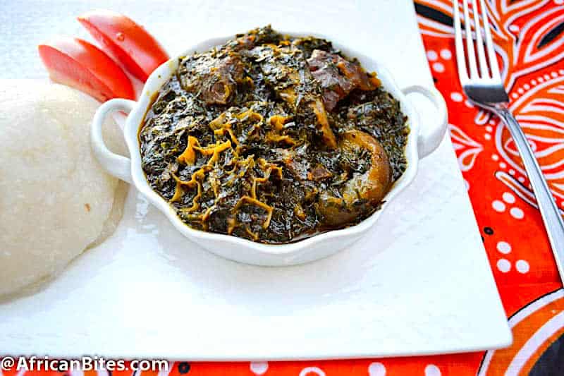 Setting down to African comfort food Afang Soup with spinach and okazi