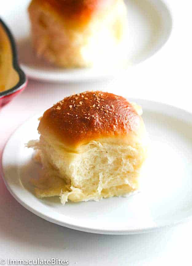Getting ready to bite into a decadent, melt-in-your-mouth pani popo coconut bread roll