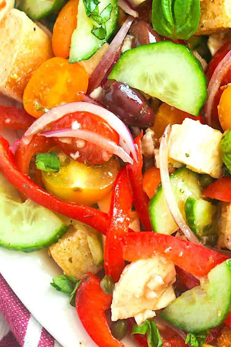 A refreshing panzanella salad with tomotoes, cucumbers and fresh veggies. A great way to use day-old bread