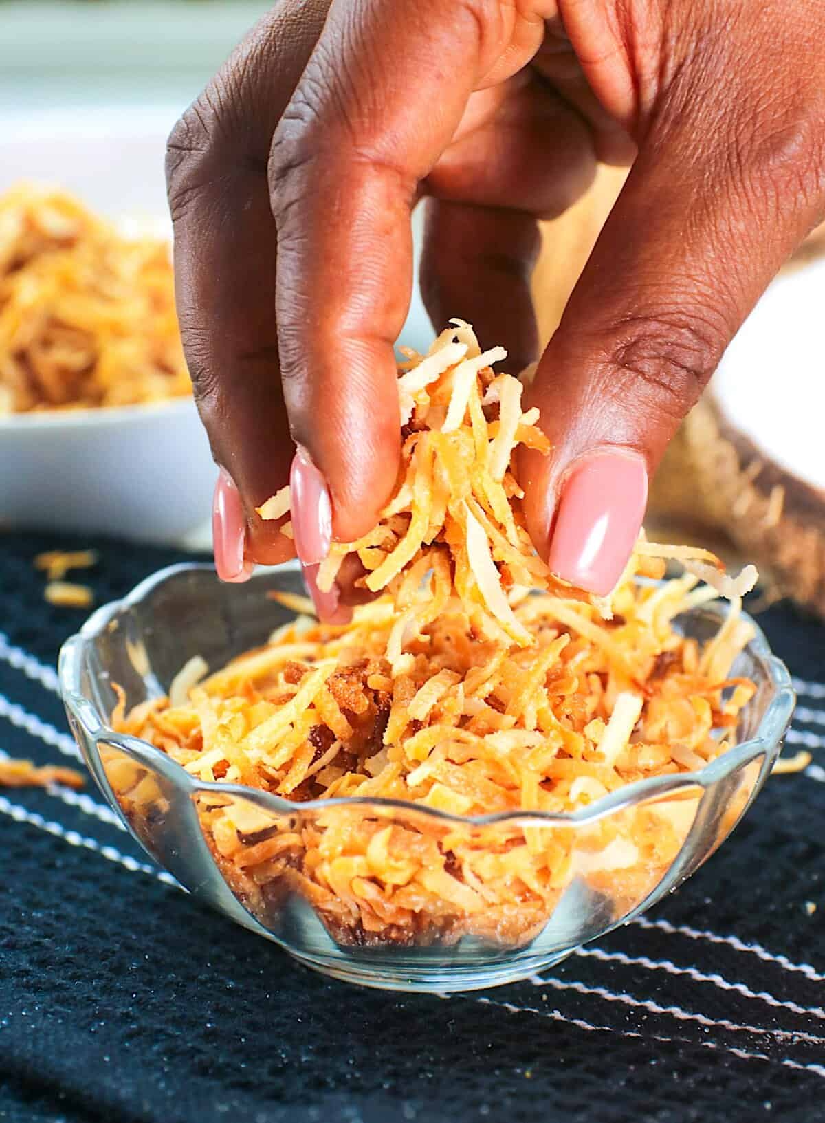 Grabbing a pinch of freshly toasted coconut to decorate your favorite dessert